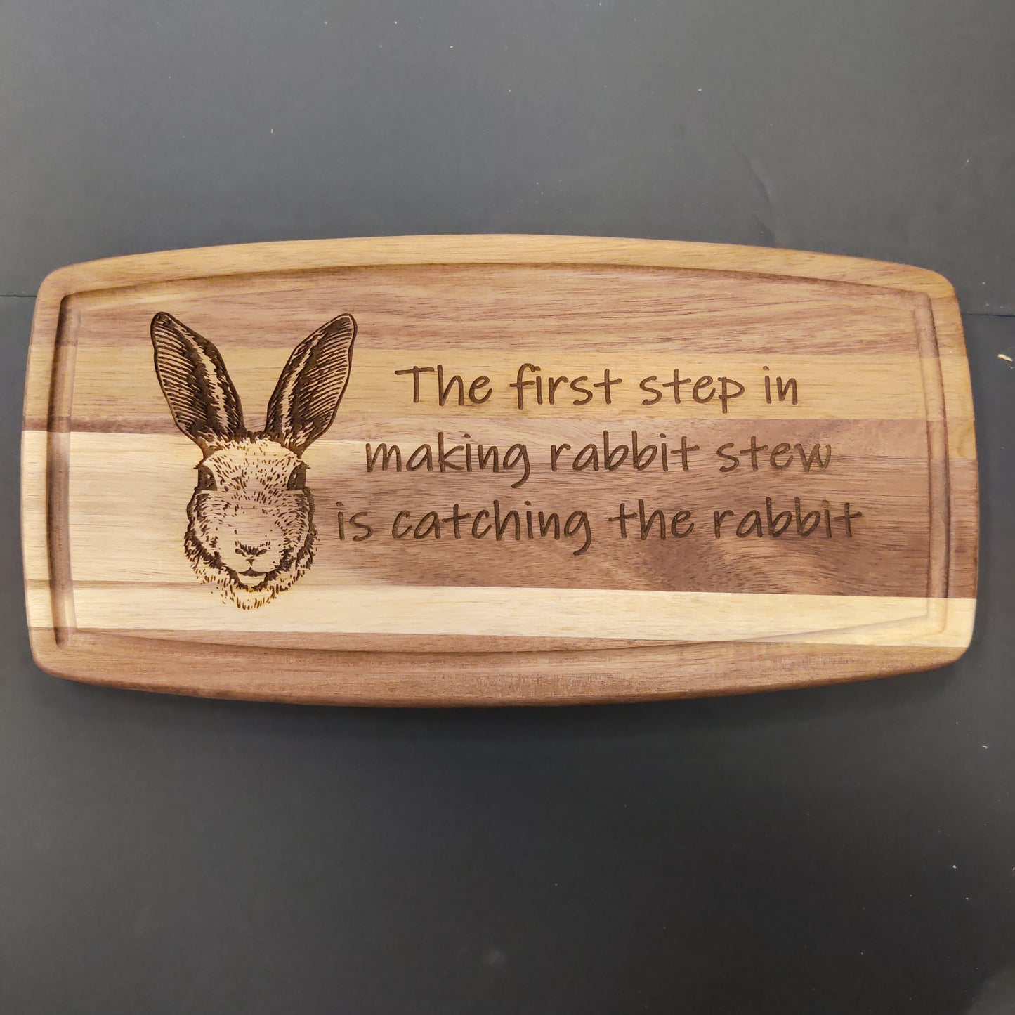 The first step to making rabbit stew is catching the rabbit wooden cutting board